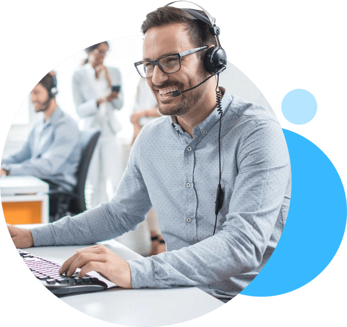 A man with headphones on sitting at a table.