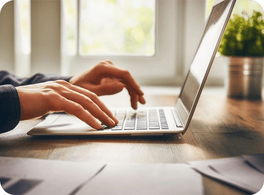 A person typing on a laptop computer.