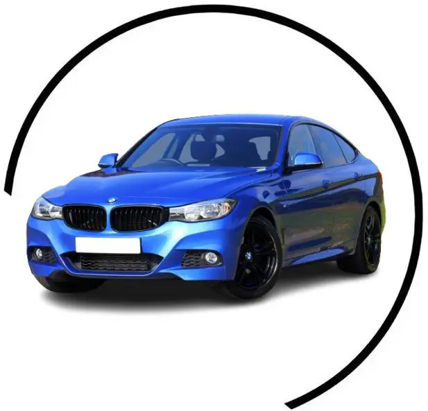 A blue car is parked in front of a black circle.